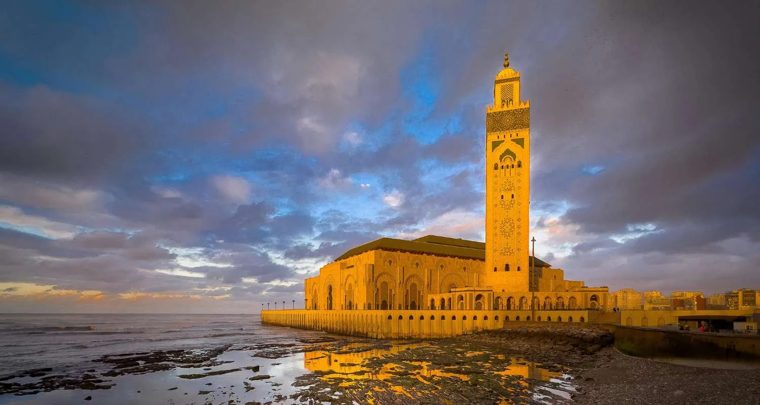 The Hassan II Mosque glowing at golden hour beside the sea in Casablanca