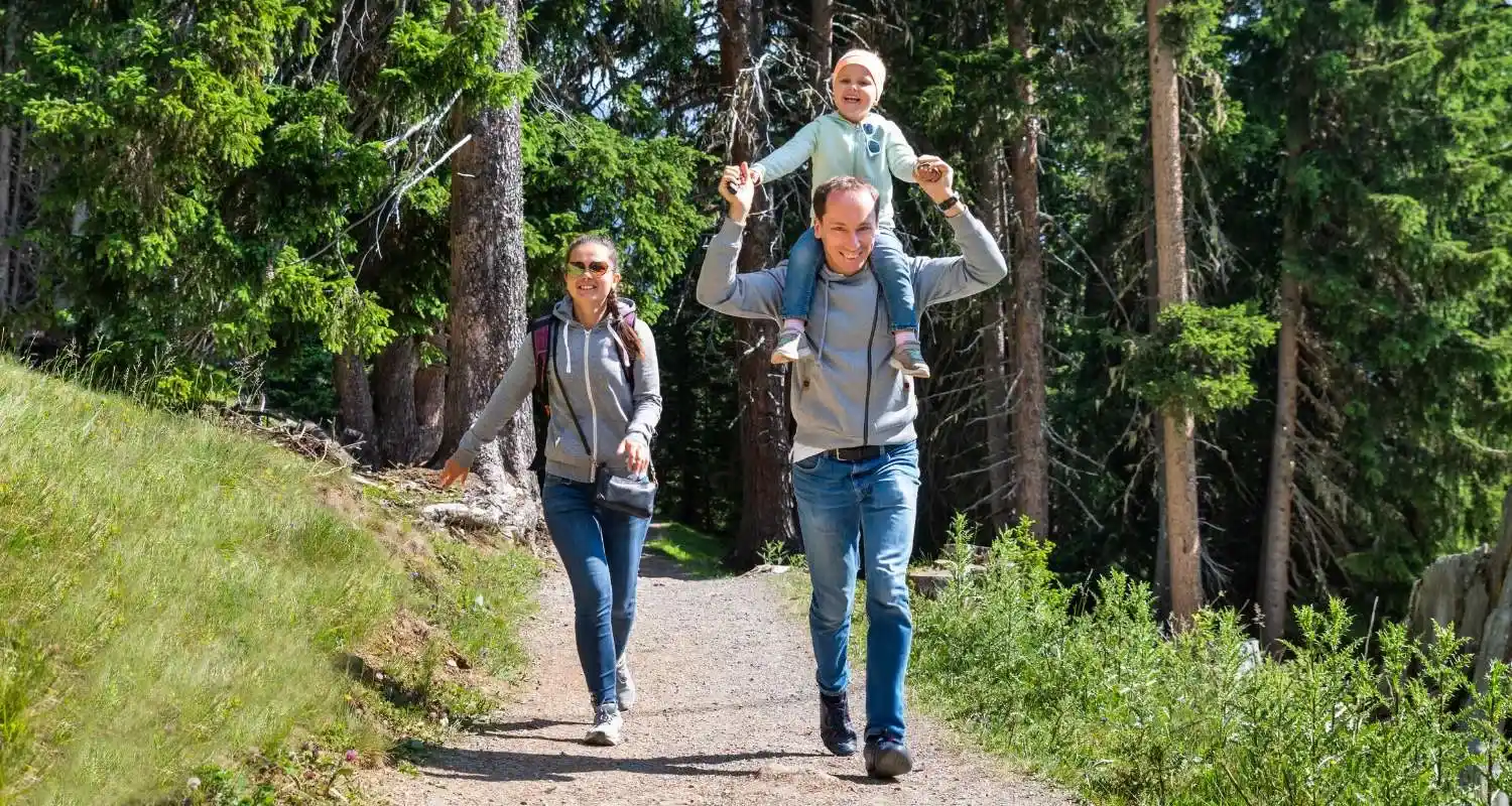 Family hiking through a forest trail in Ifrane National Park