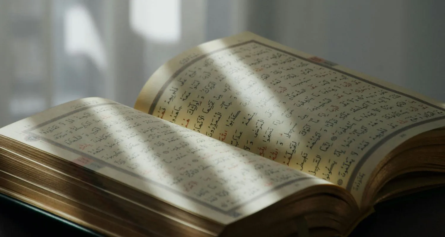 Open Ǫuran lit by afternoon light, read aloud during Mawlid in Morocco